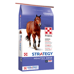 Purina Strategy Healthy Edge Horse Feed. Purple and white 50-lb feed bag.